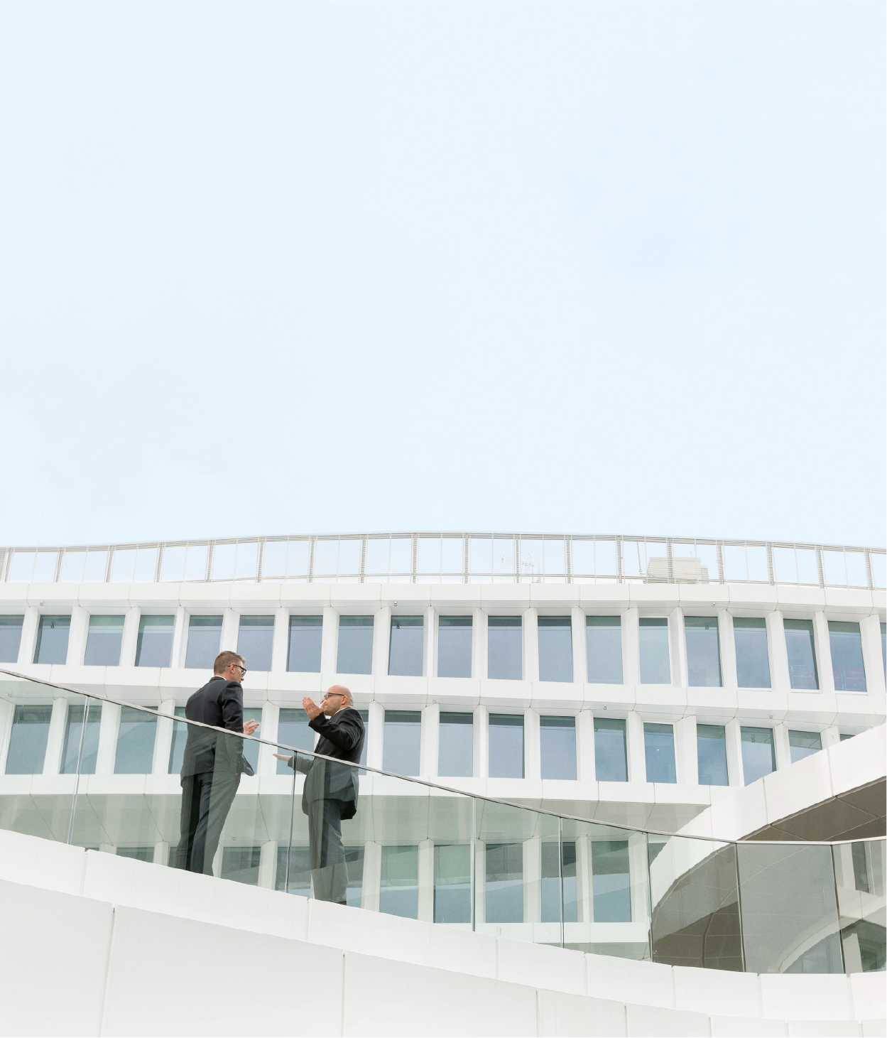 two people talking on balcony of an office building