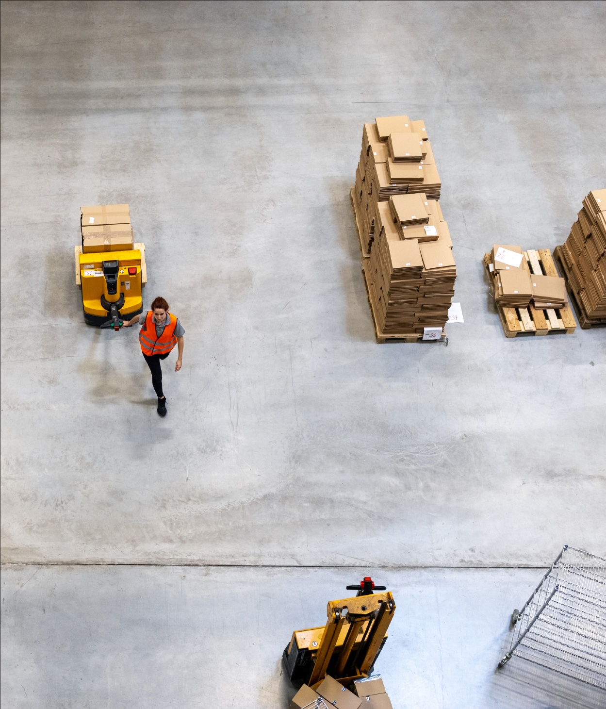 Aerial view of a warehouse employee moving packages on a pallet
