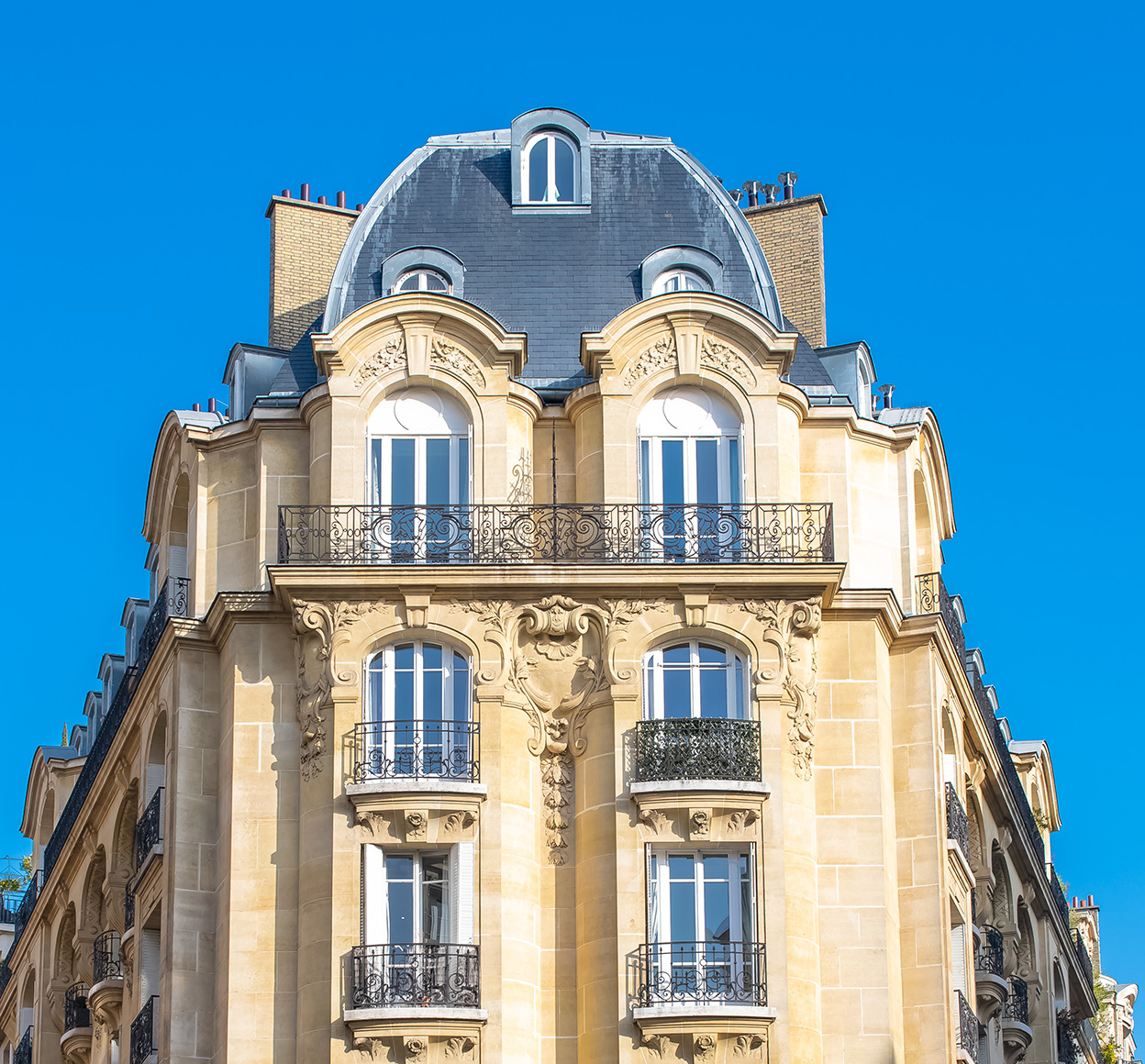 A low angle view of a typical historical stone building in Neuilly sur Seine, France, providing a sense of the scale and beauty of the architecture in the city.